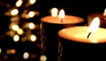 Photo of lit candles in dark setting
