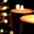 Photo of lit candles in dark setting